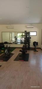 a gym with treadmills and exercise equipment in a room at Baan Suan Villas Resort in Ban Suan