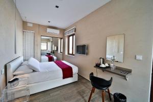 Televízia a/alebo spoločenská miestnosť v ubytovaní Quaint Boutique Hotel Nadur