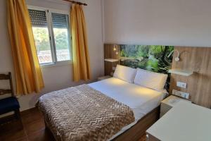 a hotel room with a bed and a window at La Terracita del Bosque in El Bosque