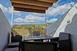 a table and chairs on a balcony with a view at La Terracita del Bosque in El Bosque