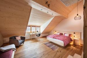 a bedroom with a bed and a desk in a room at Gähwindehof Mountain Ranch Resort in Oberstaufen