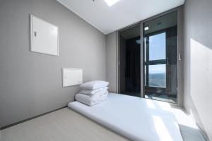 Gangneung Chonpines Ocean Suites Hotel客房内的一张或多张床位