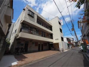 un edificio blanco al lado de una calle en Kamiyama Mansion / Vacation STAY 4357, en Osaka