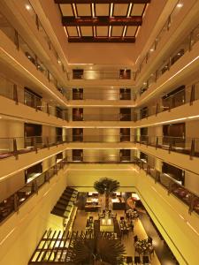 浦那的住宿－浦那瑞米格蘭德spa酒店，一座配有桌椅的建筑的空前大厅