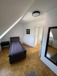 a bedroom with a bed and a mirror and a staircase at TM Apartment in Eibiswald
