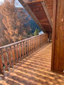 a wooden porch on a cabin with a view of the mountains at Bellavista 