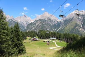 a gondola lift over a field in the mountains at Bellavista 