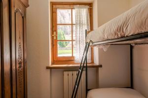 a bedroom with a bunk bed and a window at [Aosta - La Thuile] - Condominio Rolland in La Thuile