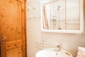 a bathroom with a sink and a mirror at [Aosta - La Thuile] - Condominio Rolland in La Thuile