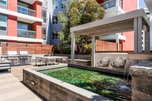 Una piscina al aire libre con jacuzzi y un patio con sillas. en Redwood City 1br w gym lounge wd nr Caltrain SFO-1232, en Redwood City
