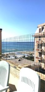 a view of the beach from the balcony of a condo at Casa Gaia in Albissola Marina +2 photos