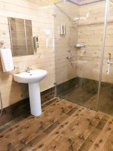 a bathroom with a sink and a shower at Brahmi Resort in Bangalore