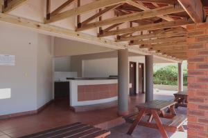 an open kitchen and dining area with a wooden ceiling at Laguna la Crete 66 in Uvongo Beach