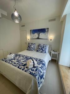 a bedroom with a bed with blue and white sheets at L'albero della vita in Minori