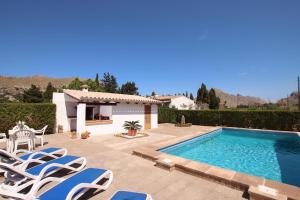 a villa with a swimming pool and lounge chairs at Villa La Vinya Can Oliver - Oliver in Pollença