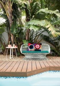 a white bench sitting next to a pool at THE BIG - Luxury Backpackers in Cape Town