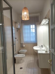 a bathroom with a sink and a toilet and a mirror at Casa Teranga in Furore +37 photos