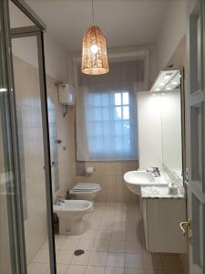 a bathroom with a sink and a toilet and a mirror at Casa Teranga in Furore