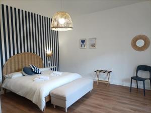 a bedroom with a white bed and a chair at Casa Teranga in Furore