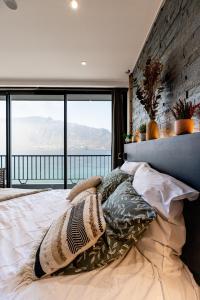 a bedroom with a large bed with a view of the ocean at L'Edelweiss du Lac in Tresserves