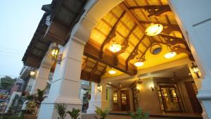 a lobby of a building with a ceiling at Hotel Vijayetha in Nāgercoil