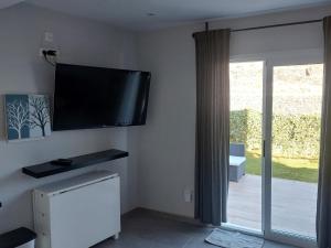 a living room with a flat screen tv on the wall at modern holiday apartment with private pool in Adeje