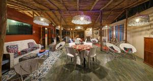 a dining room with a table and chairs at Gala Gala Eco Resort in Ponta do Ouro