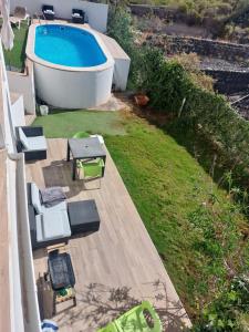 an aerial view of a backyard with a bath tub and a pool at modern holiday apartment with private pool in Adeje +17 photos