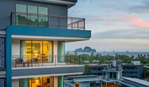 a building with a balcony with a view of the ocean at AVA SEA Resort Krabi, Ao Nang Beach in Ao Nang Beach