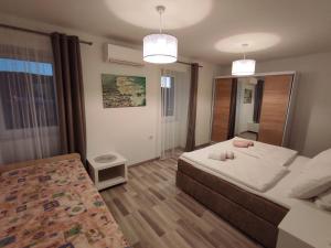 a bedroom with a large bed and two lights at Holiday House Santa in Lopar