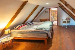 a bedroom with a large bed in a attic at The Boathouse in Velddrif