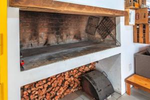 a brick oven with a pile of fire wood at The Boathouse in Velddrif