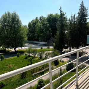 a park with a bench next to a river at TOURIST HOTEL in Shymkent +10 photos