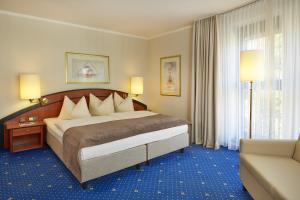 Кровать или кровати в номере H4 Hotel Hamburg Bergedorf