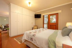 a bedroom with a bed and a television in it at Kruger Allo View B&B in Komatipoort