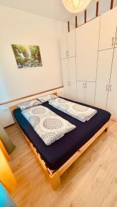 Bett in einem Zimmer mit weißen Schränken in der Unterkunft Blue Sun in Ljubljana