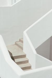 a staircase in a house with white walls at Casa Vitae Suites in Kamari +70 photos