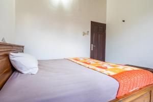 Postel nebo postele na pokoji v ubytování Surya Villa Manggis