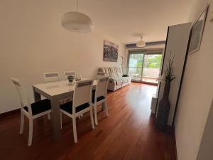 a dining room and living room with a table and chairs at Altos del Toril 2 habitaciones Wifi y Parking in Torremolinos