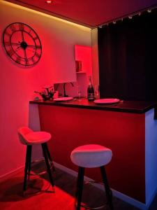a red room with two stools and a bar at Secret Night II in Toulouse