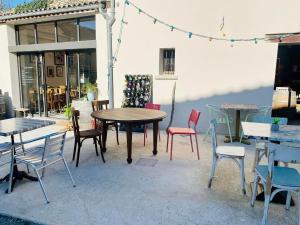 a group of tables and chairs in a patio at La LocaLuna in Civray-de-Touraine