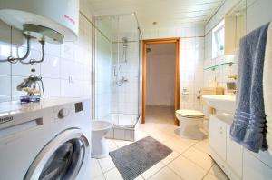 a white bathroom with a washing machine in it at Apartment Mladen in Krk