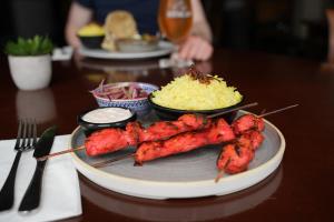 a plate of food with meat and rice on a table at Mulranny Park Hotel in Mulranny