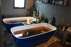 a bath tub with a sink in a bathroom at Mulranny Park Hotel in Mulranny