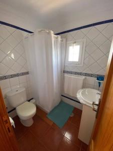 a small bathroom with a toilet and a sink at Cosy twin beds La Baja in Santa Cruz de Tenerife