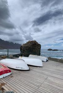 a group of surfboards lined up on a wooden pier at Cosy twin beds La Baja in Santa Cruz de Tenerife