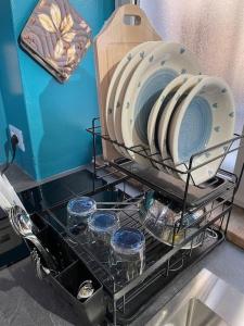 a drying rack with plates and bowls on it at Perugia Home Apartment La Finestra Di Fronte in Perugia