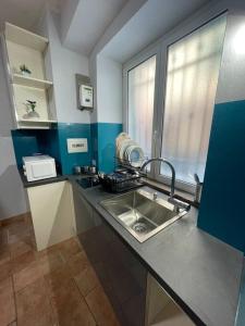 a small kitchen with a sink and a window at Perugia Home Apartment La Finestra Di Fronte in Perugia