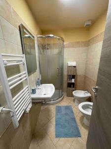 a bathroom with a shower and a toilet and a sink at Perugia Home Apartment La Finestra Di Fronte in Perugia +10 photos