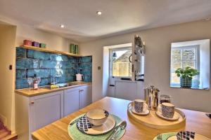 a kitchen with a wooden table and a sink at The Snug at Ruston, Cosy Dog Friendly Cottage in Wykeham +23 photos